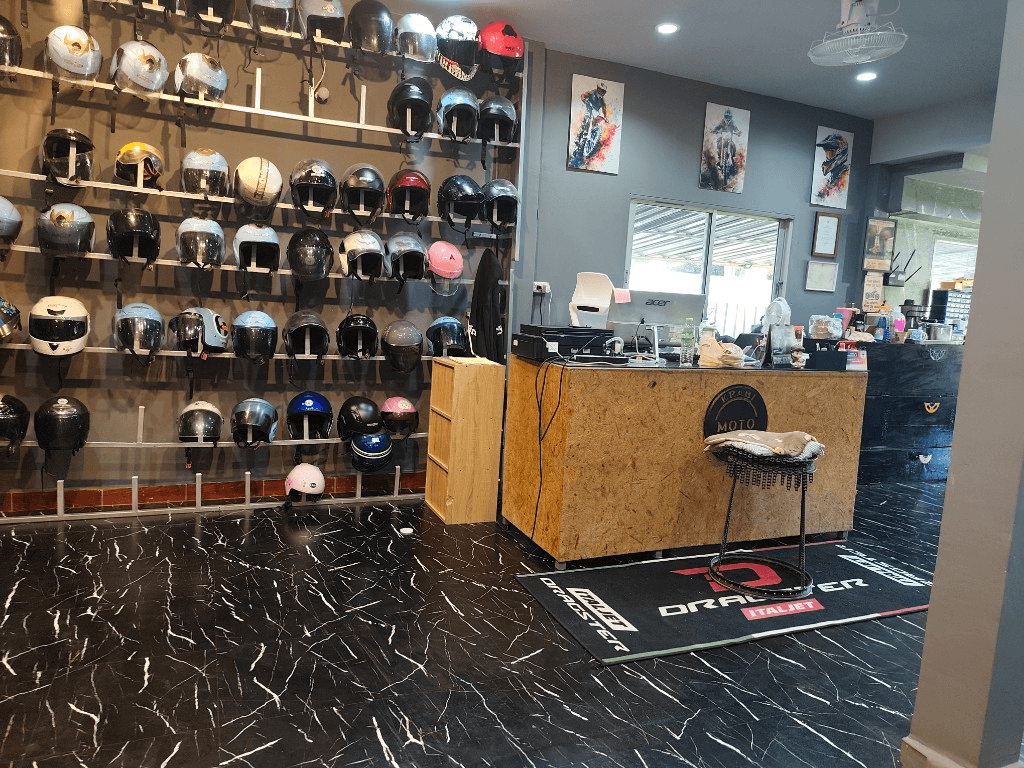 Krabi Moto Rentals front desk with helmet racks and service counter