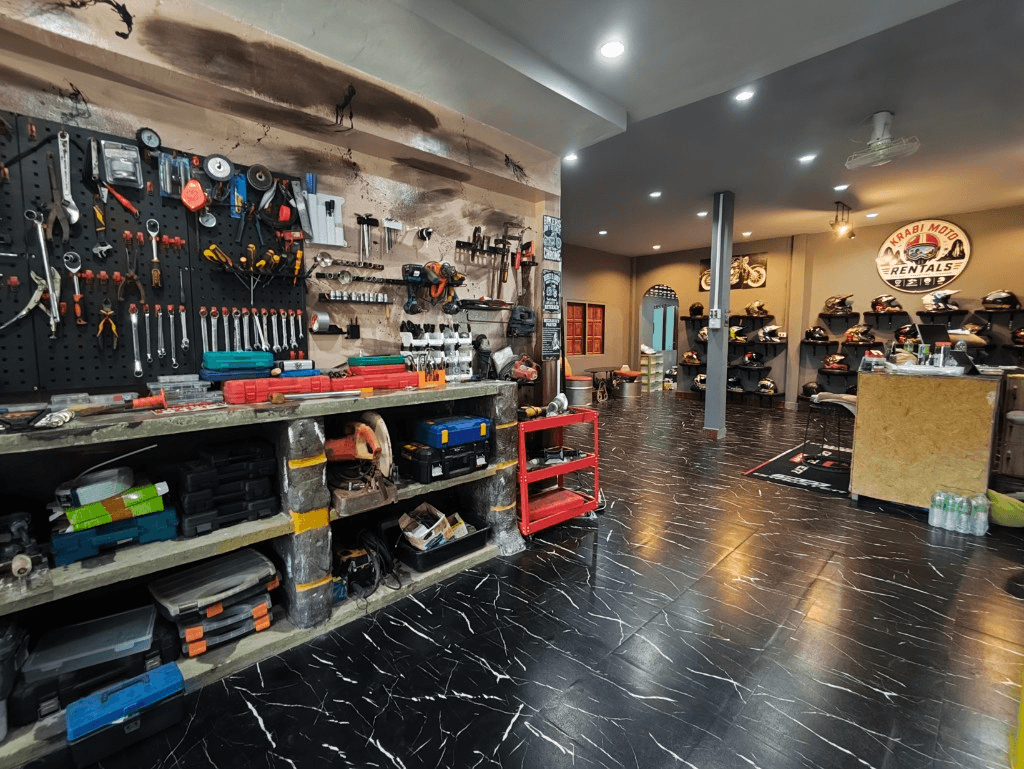 Krabi Moto Rentals shop interior with workshop, showroom and helmet displays