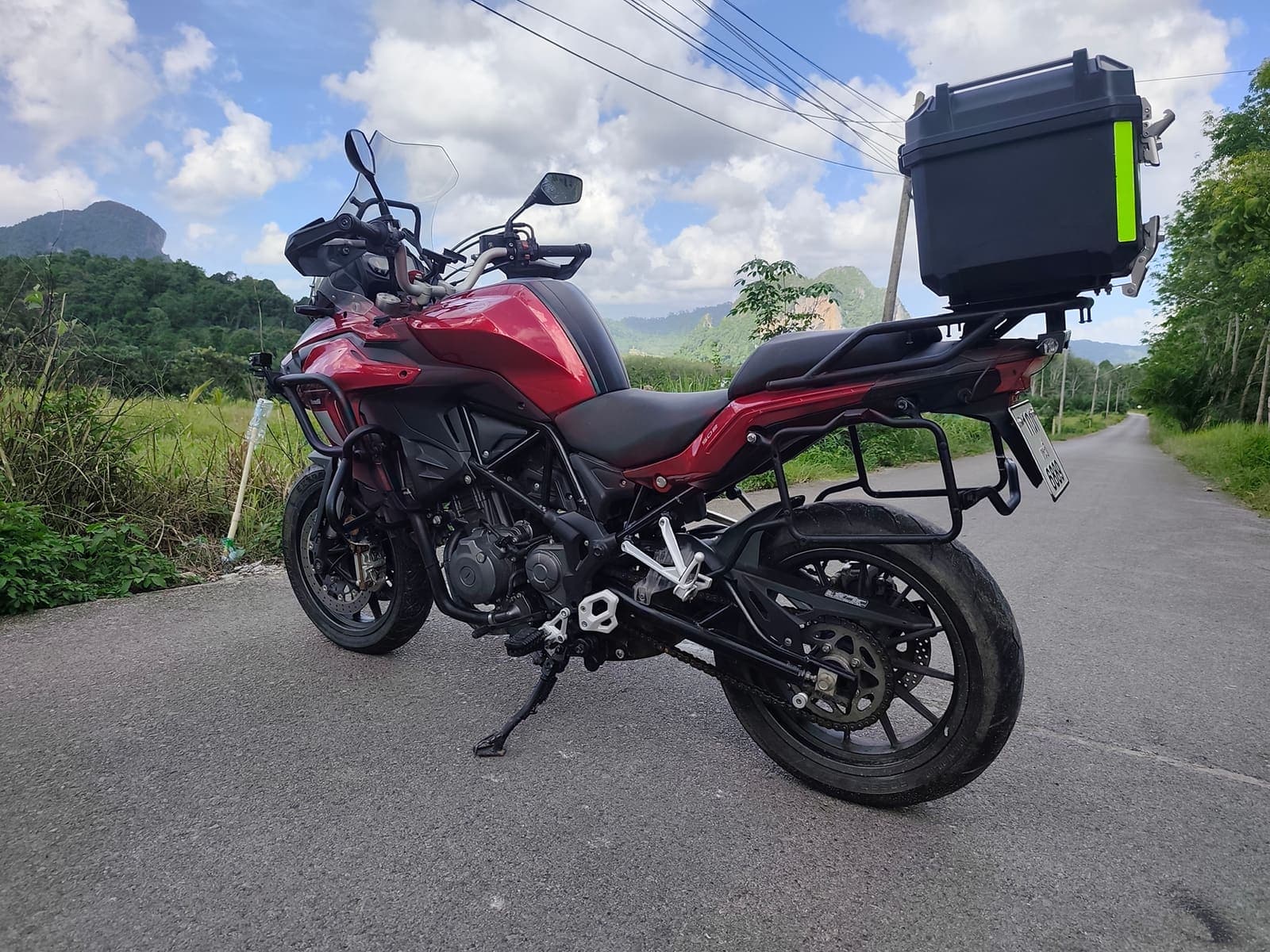 Benelli TRK 502 side profile on a scenic Krabi road