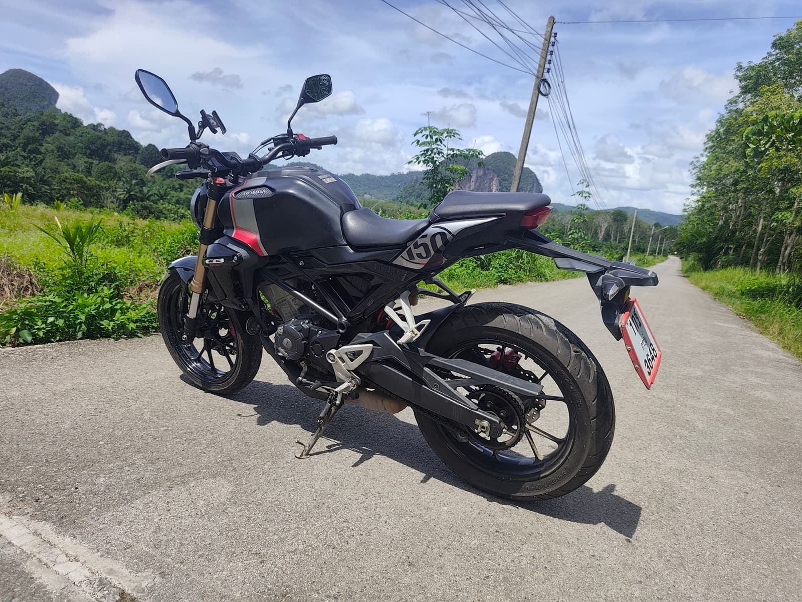 Honda CB150R side profile on a scenic Krabi road
