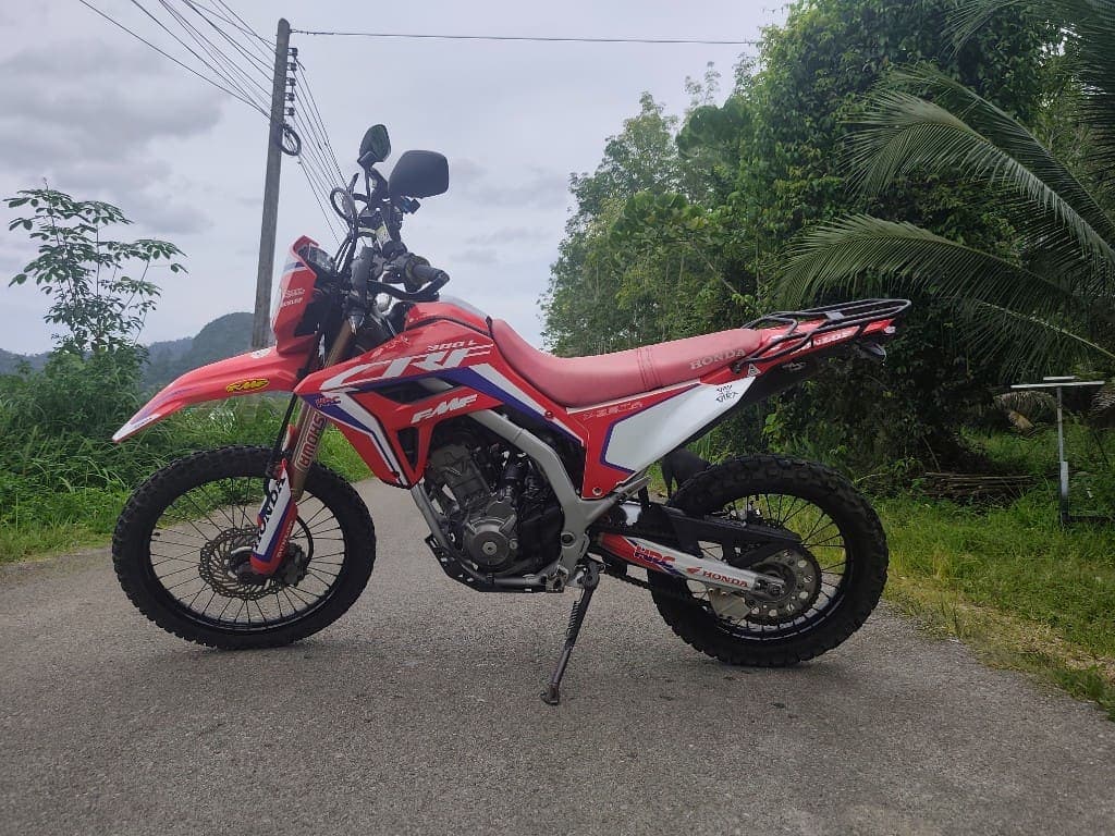 Honda CRF300L side profile on a scenic Krabi road