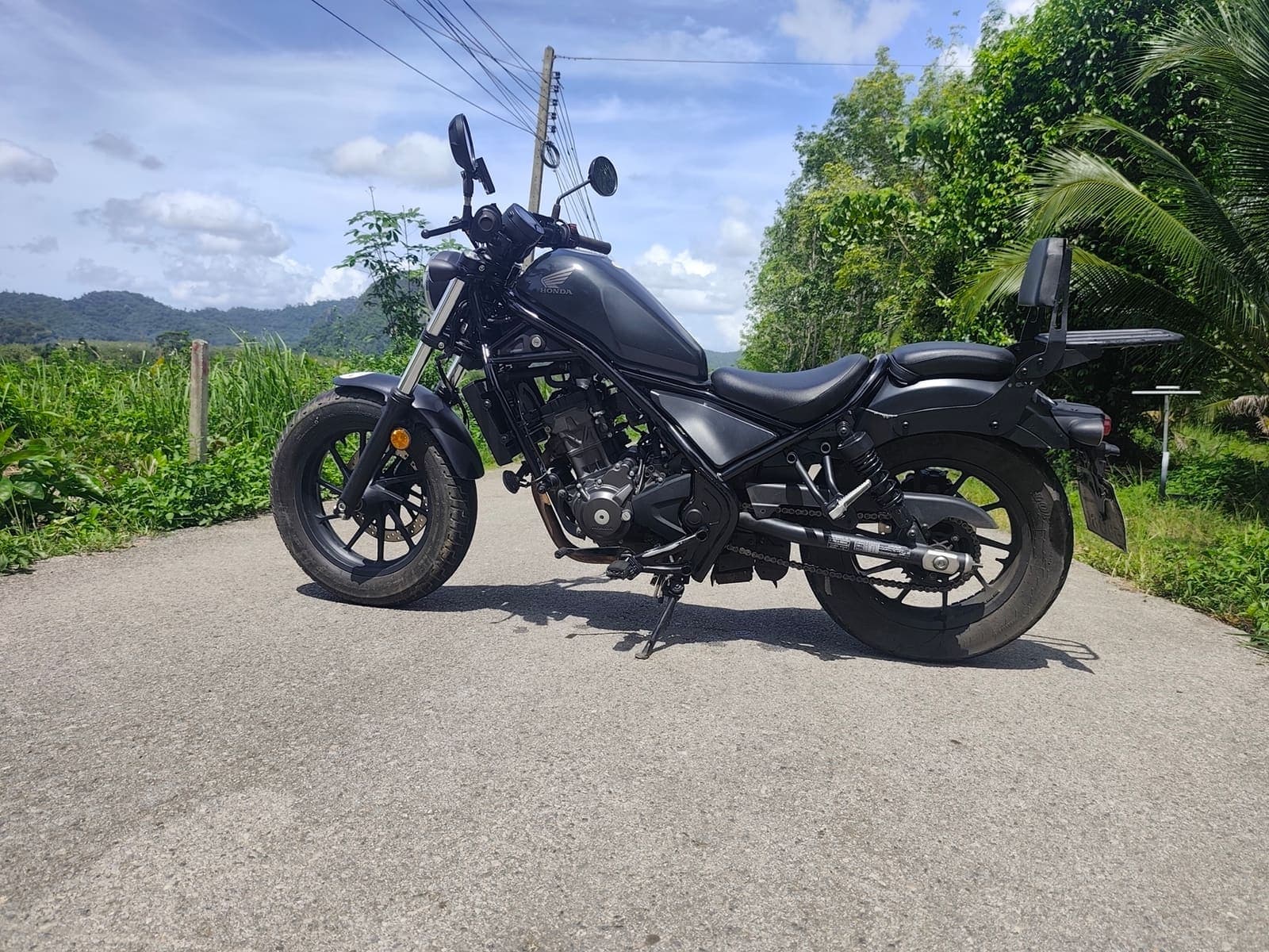 Honda Rebel 300 side profile on a scenic Krabi road
