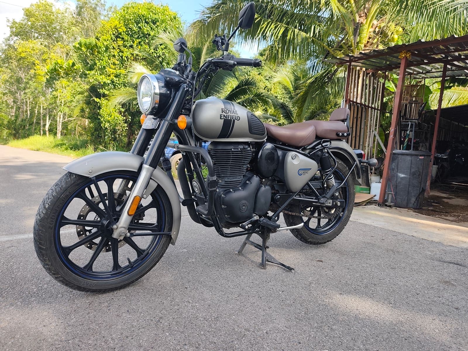 Royal Enfield Classic 350 side profile on a scenic Krabi road