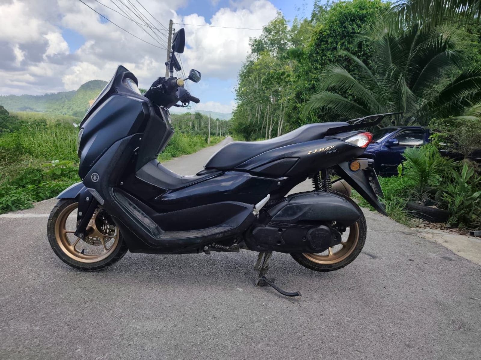 Yamaha NMAX 155 side profile on a scenic Krabi road