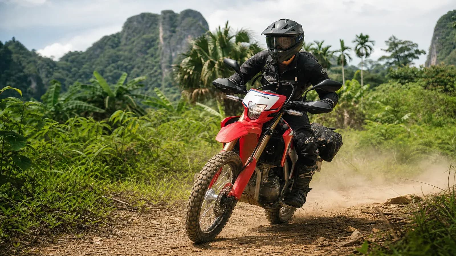 Rider on a Honda CRF300L adventure bike on a light off-road trail near Krabi
