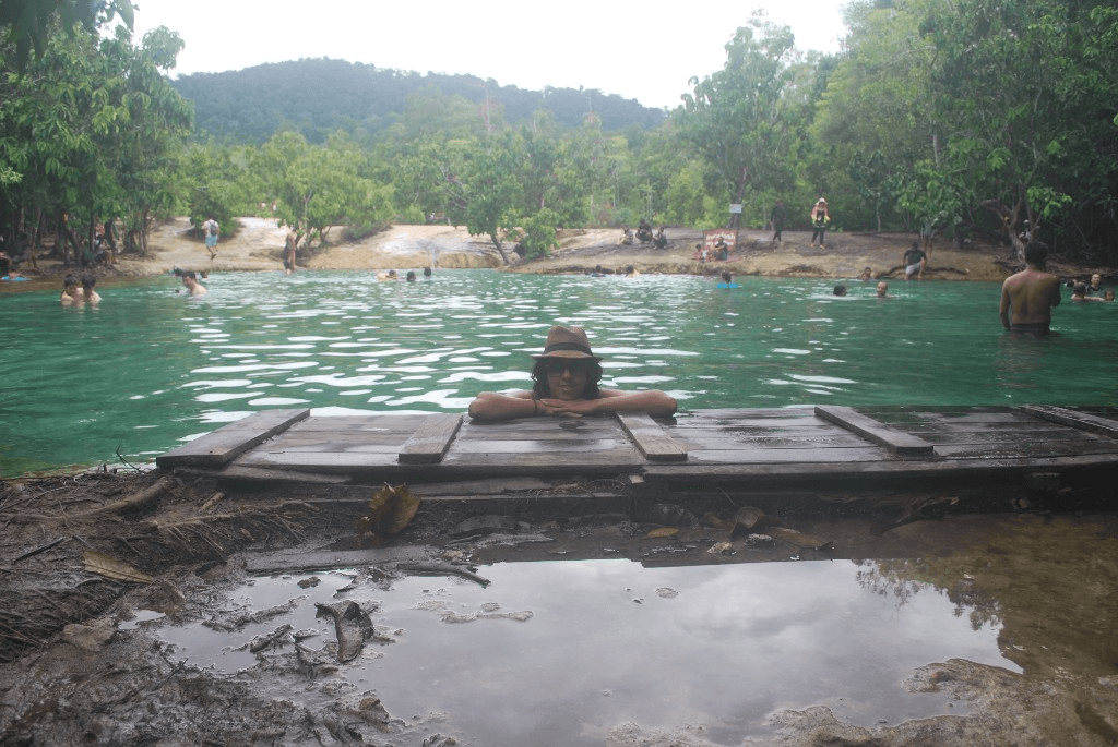 Emerald Pool with visitors wading in the mineral-green water at Thung Teao Forest Natural Park