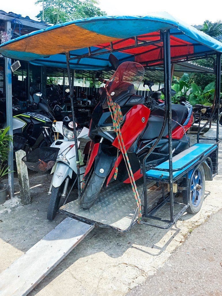Krabi Moto Rentals roadside assistance vehicle loading a damaged Yamaha XMAX scooter for recovery