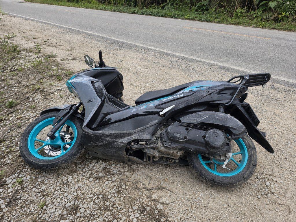 Damaged Yamaha Aerox rental scooter lying on its side after a minor accident in Krabi