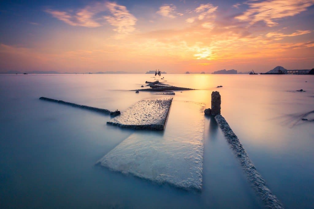 Long-exposure sunset at Klong Muang with offshore karsts and calm Andaman Sea