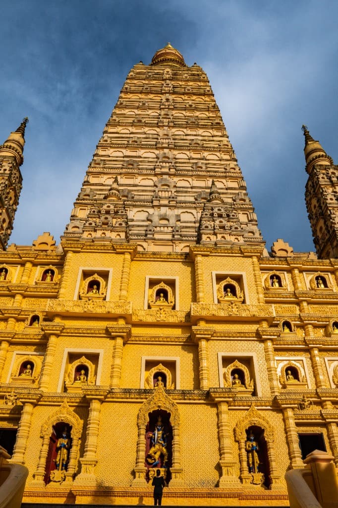 Golden chedi and Buddha niches at Wat Bang Thong temple, Krabi