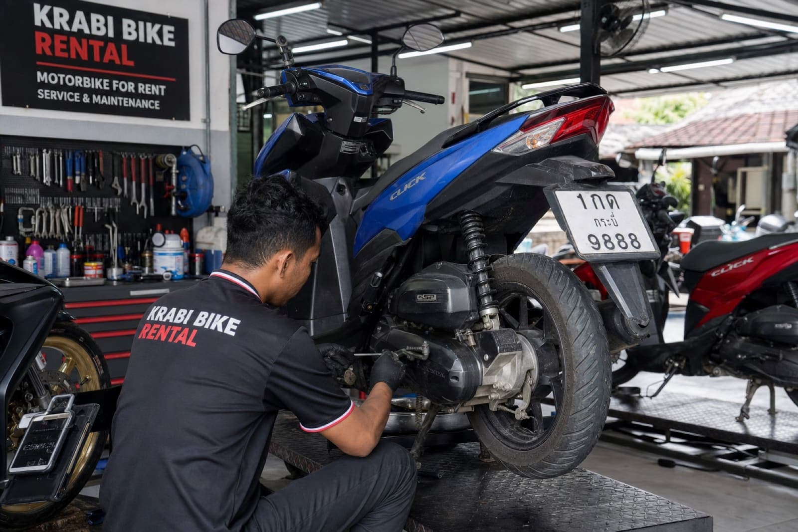 Krabi Moto Rentals mechanic servicing rental motorcycles in the workshop