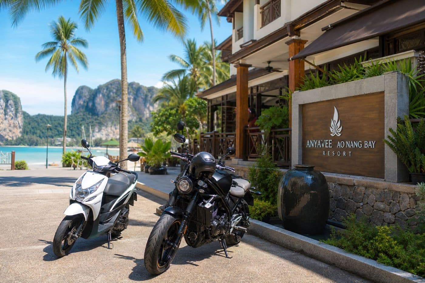 Rental scooters parked outside a beachfront hotel in Ao Nang Krabi