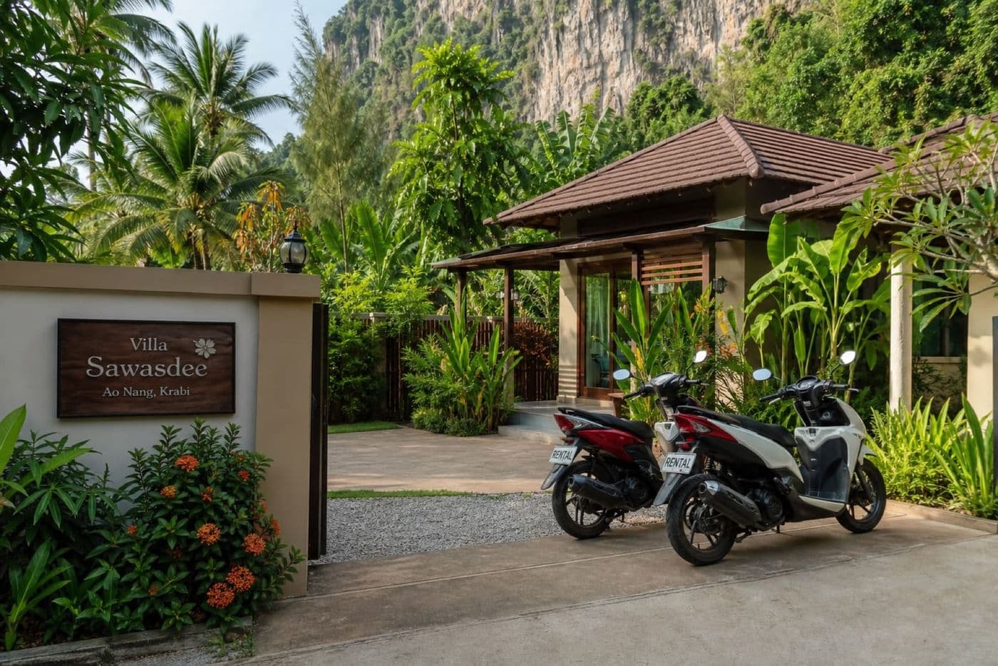 Rental scooters parked outside a private villa in Krabi