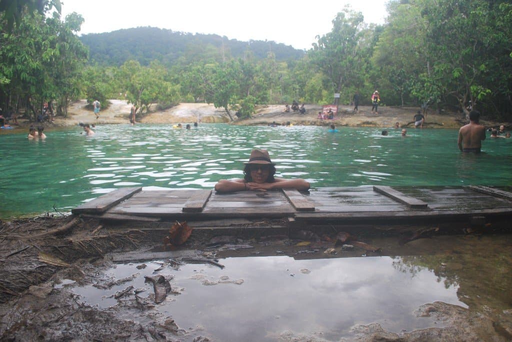 Emerald Pool with visitors wading in the mineral-green water at Thung Teao Forest Natural Park