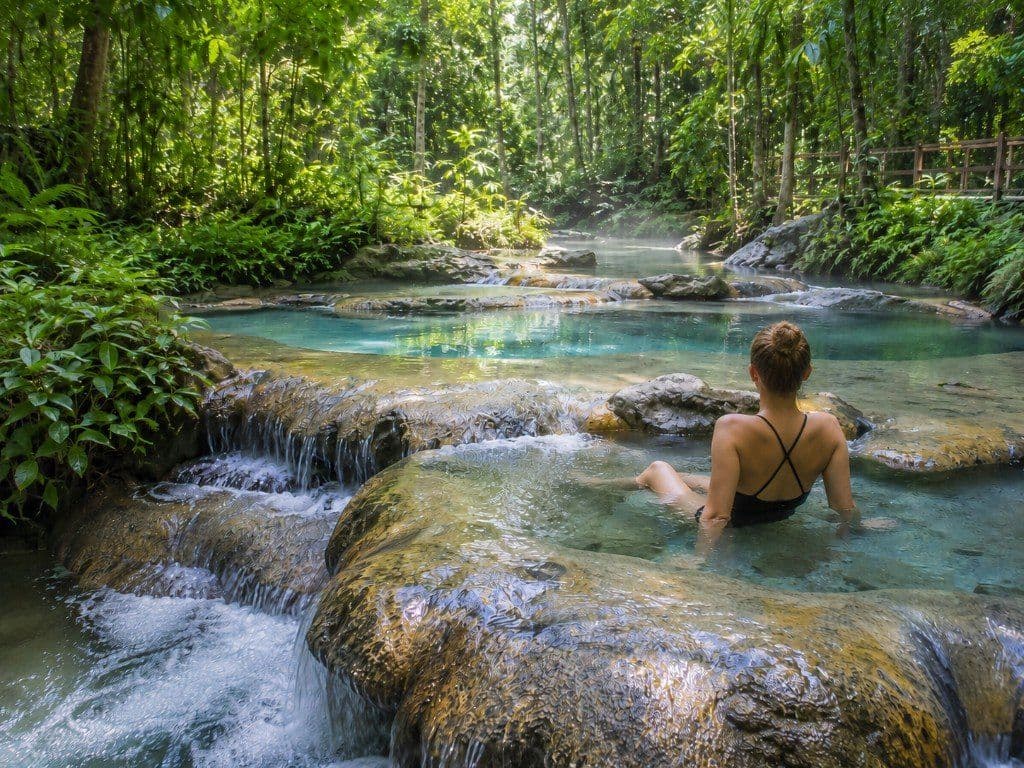 Visitor relaxing in the natural rock pools at Krabi Hot Springs, Khlong Thom