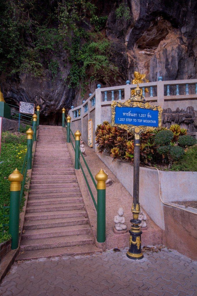 Sign at the base of Tiger Cave Temple staircase showing steps to the mountaintop