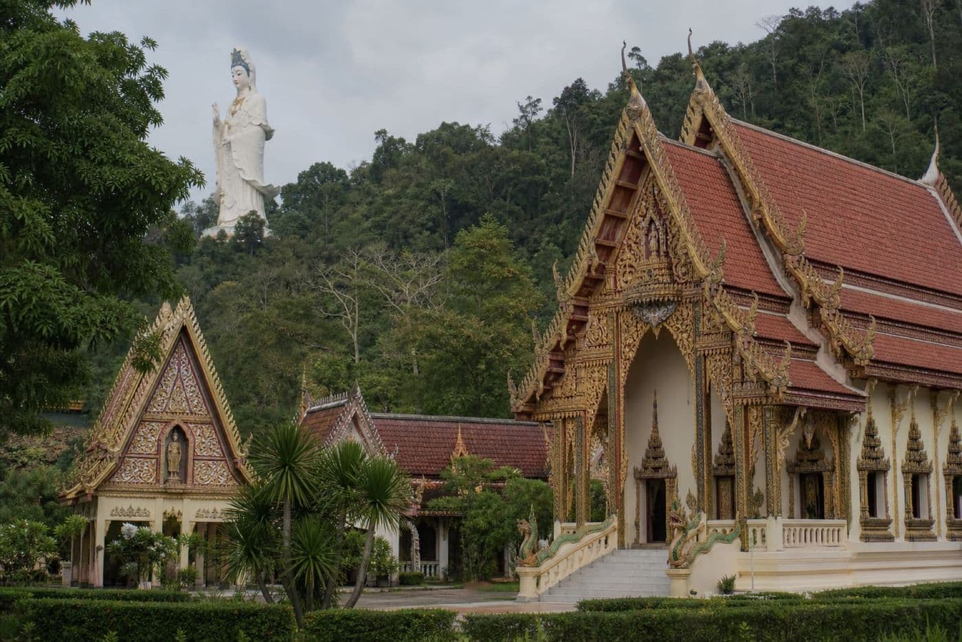 Wat Bang Riang temple halls with the hilltop Guan Yin statue, Phang Nga Province