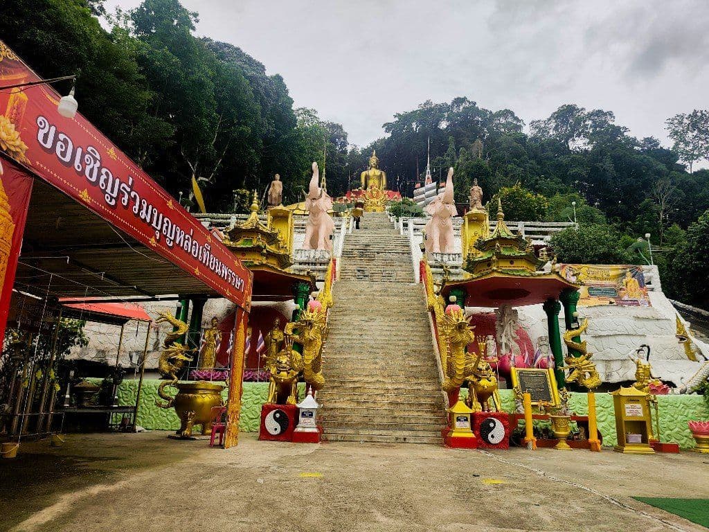Steep stone staircase with golden dragon pillars leading to the golden Buddha at Wat Phu Khao Phra Maha Bodhisattva, Ao Nang