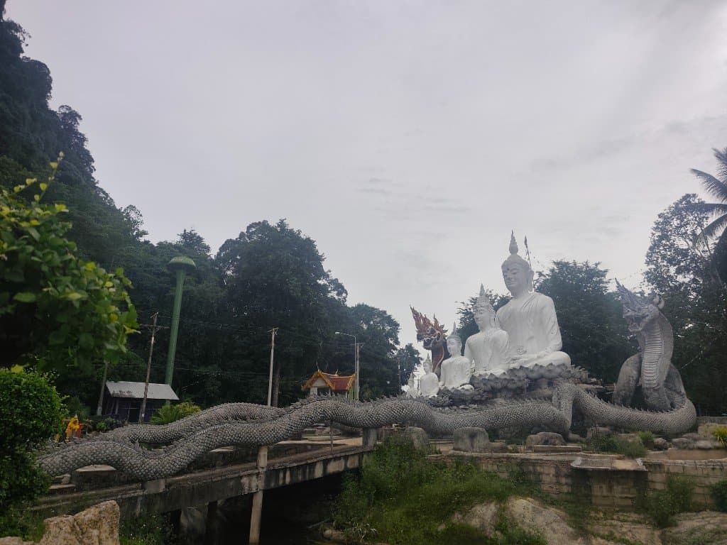 White Buddha statues and Naga bridge at Wat Nong Chik community temple, Khao Khram, Krabi Province